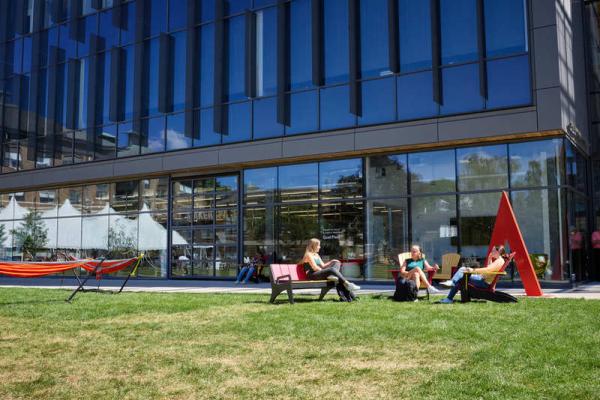 Students sitting in Adirondack chairs on the Wentworth Quad in front of CEIS