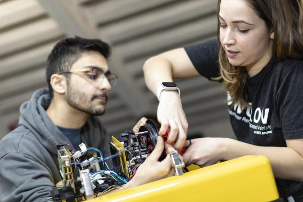 Two students work on a robotics project together in the Wentworth Annex