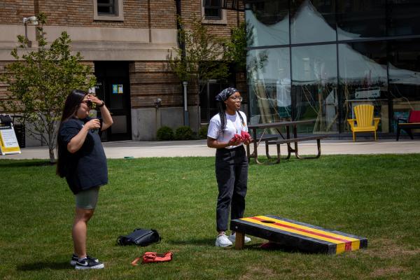 Wentworth alumni play cornhole on the quad