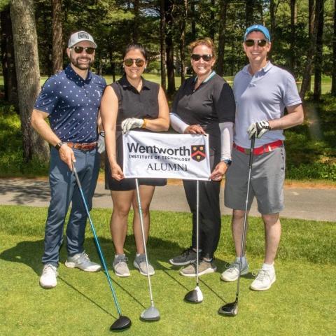 Four alumni stand together at the Wentworth Alumni Golf Tournament